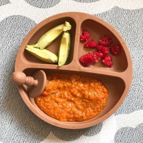 Tomato couscous served with fruit and avocado slices