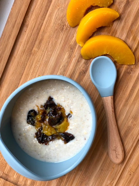 Prune and peach porridge served with peach slices